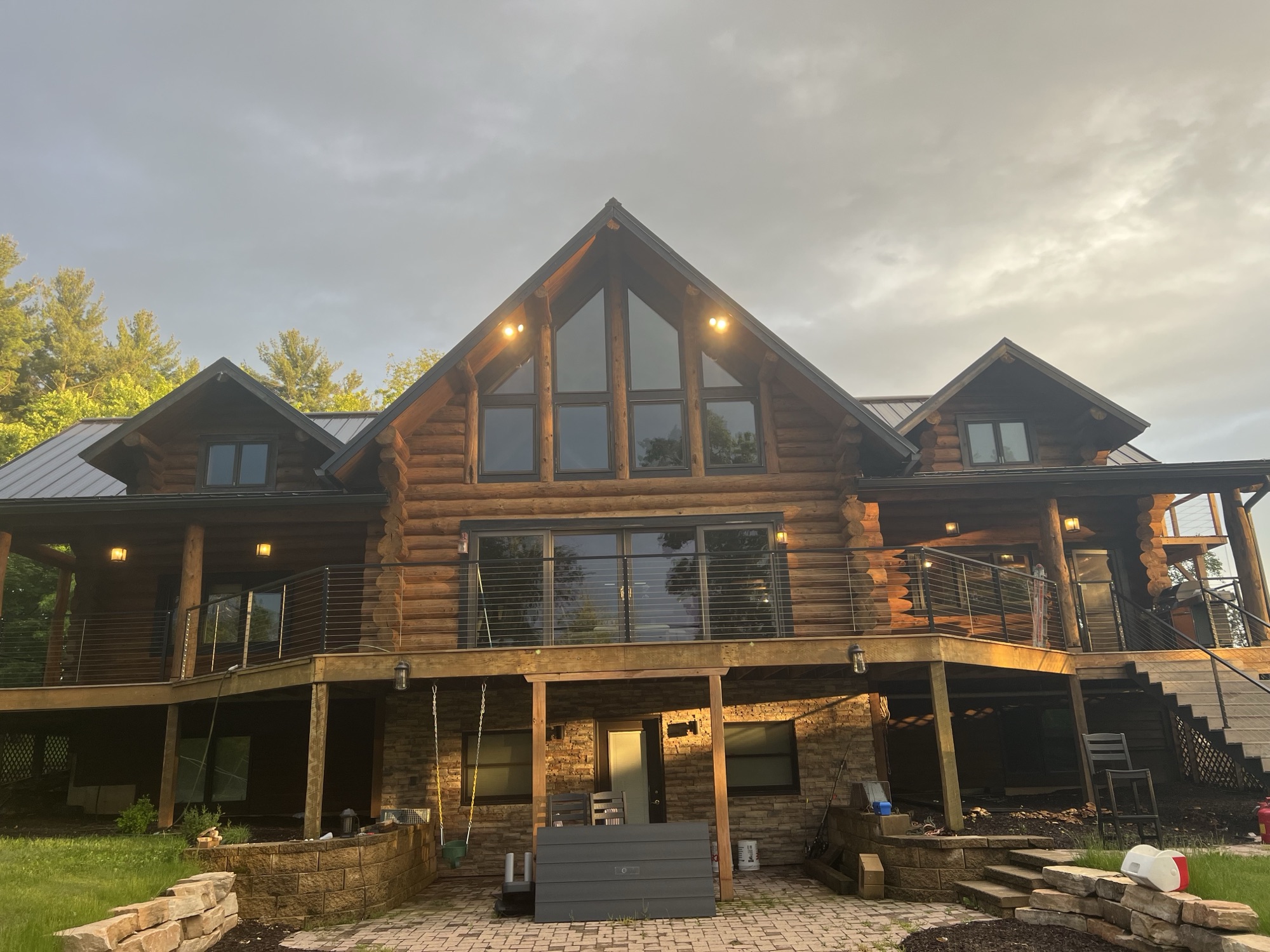 Log home rear deck sunset