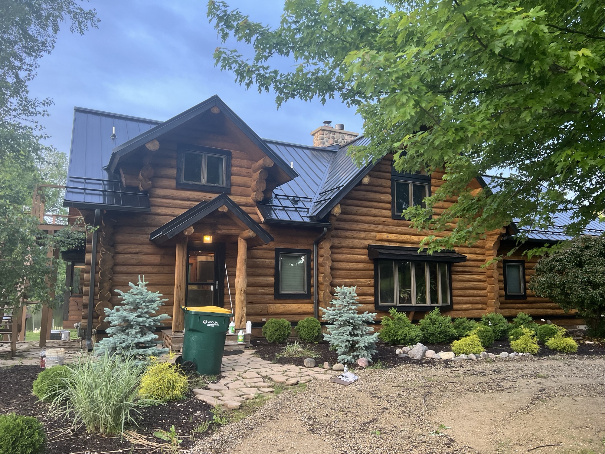 Log home exterior stained and restored by Property Restoration Solution