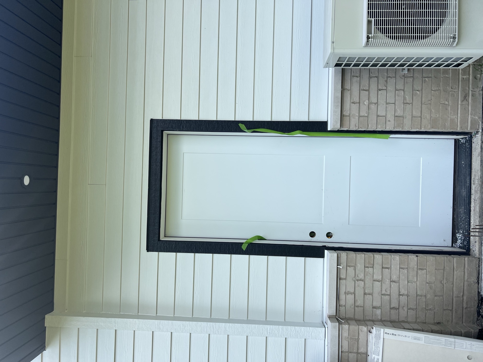 White siding brick wainscot door